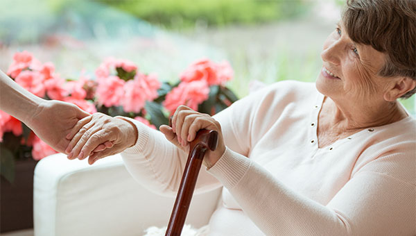 lady smiling with a cane