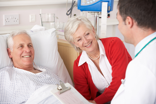 male physician speaking with a patient and his wife