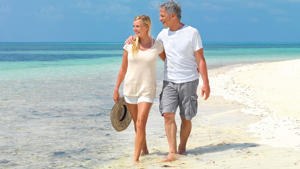Man and woman walking along a beach