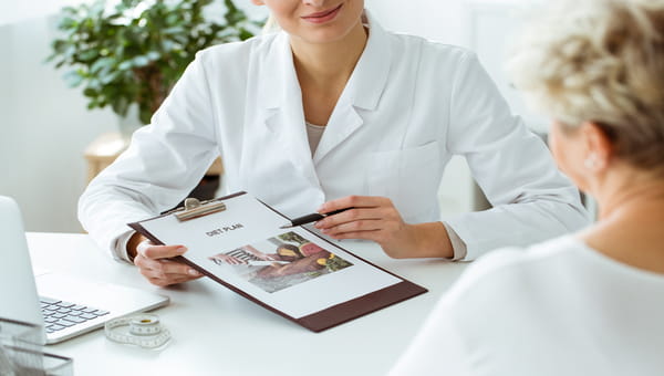 Medical staff explaining diet plan to patient