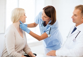 A woman having her throat examined