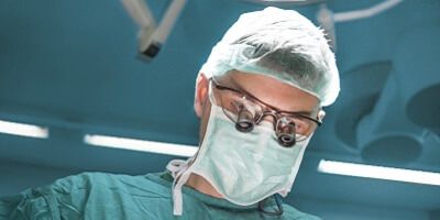 surgeon wearing scrubs and protective equipment