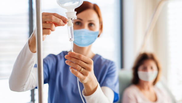 A HomeCare team member is helping a patient with her home infusion therapy.