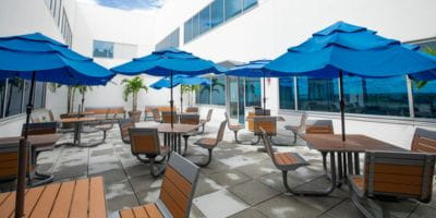 The NICU outdoor balcony with tables and chairs outside the South Florida Baptist Hospital