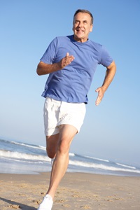 A senior man running on the beach