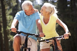 A senior couple on bicycles enjoying good weather