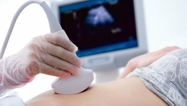 Babys Heart Development pregnant woman on hospital bed getting sonogram