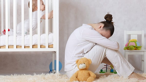 Young mother between 30 and 40 years old is experiencing postnatal depression