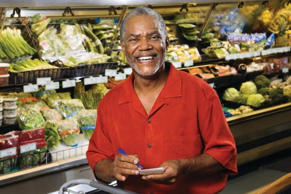 smiling grocery shopping man with a list
